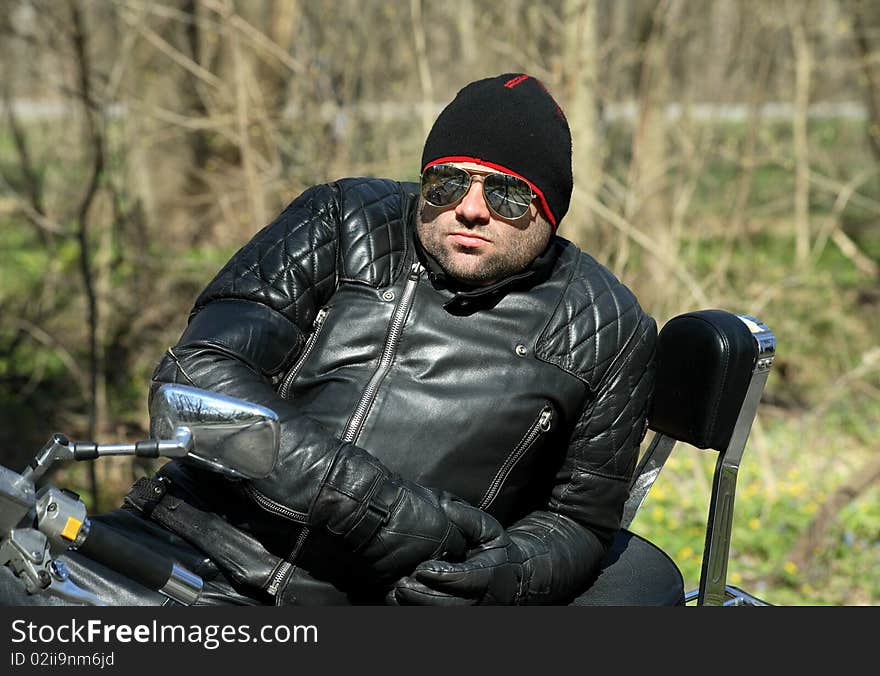 Biker sitting on his motorcycle, cool man