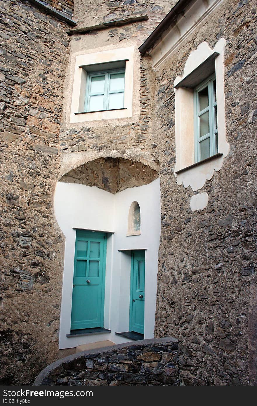 Front of an old stone house in an ancient restored village in northern italian country. Front of an old stone house in an ancient restored village in northern italian country