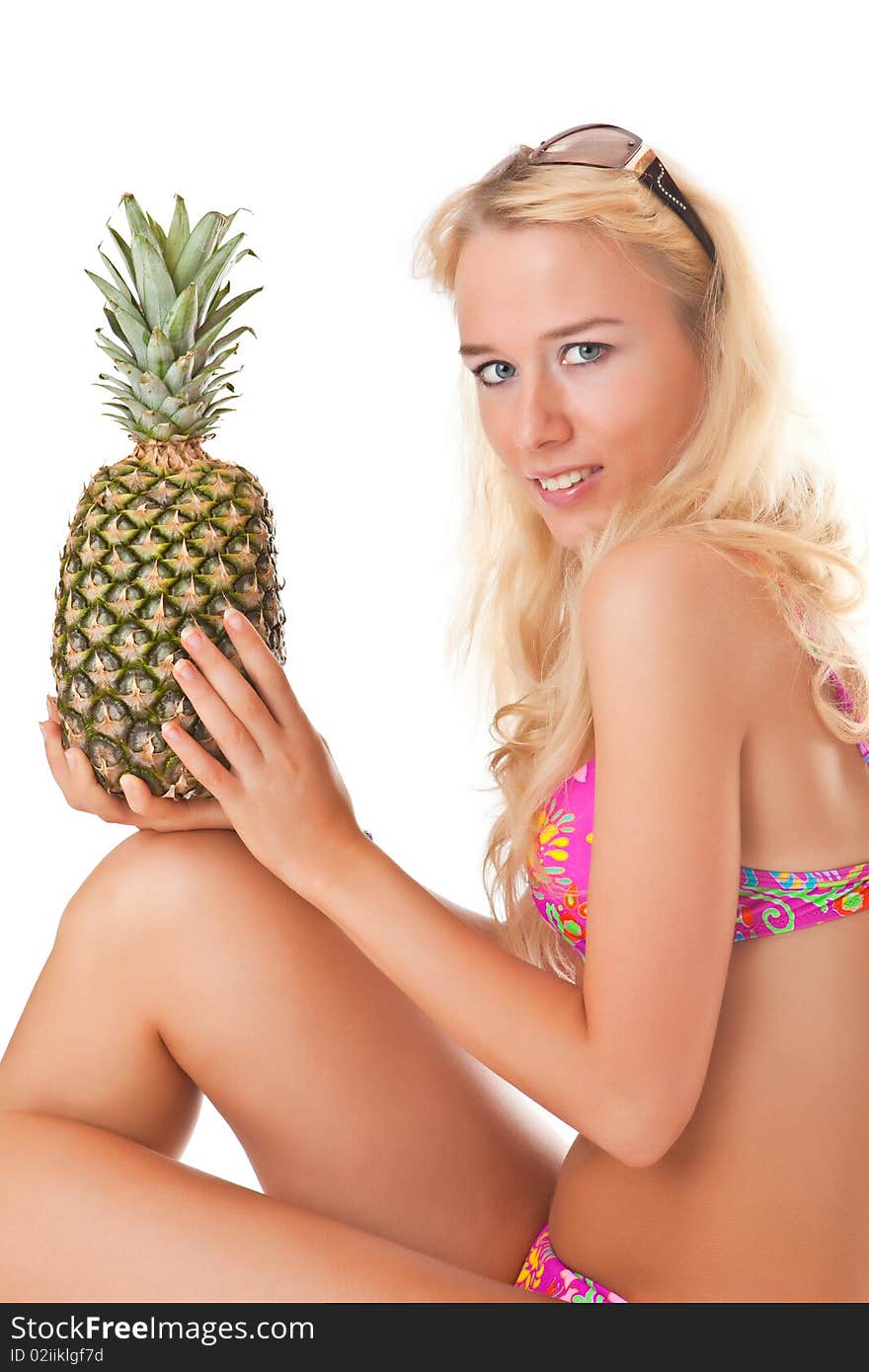 Beautiful girl in bikini with pineapple