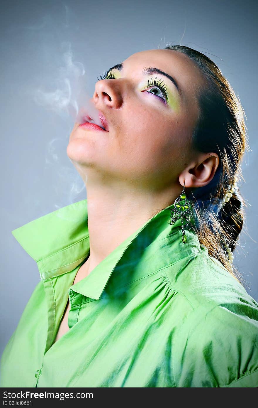 Portrait of young beautiful woman smoking.