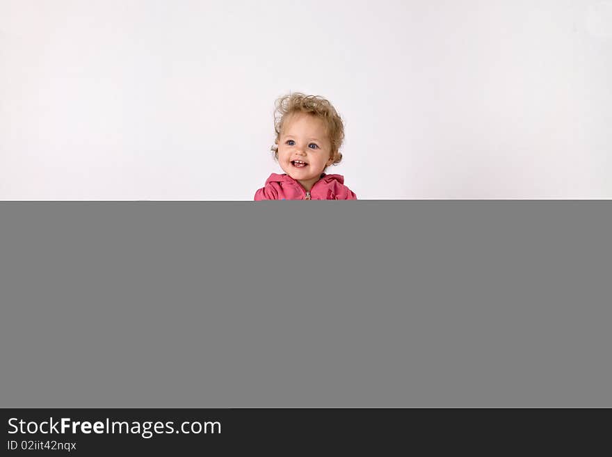 A little girl sitting between colorful baloons with a birthday cake. A little girl sitting between colorful baloons with a birthday cake