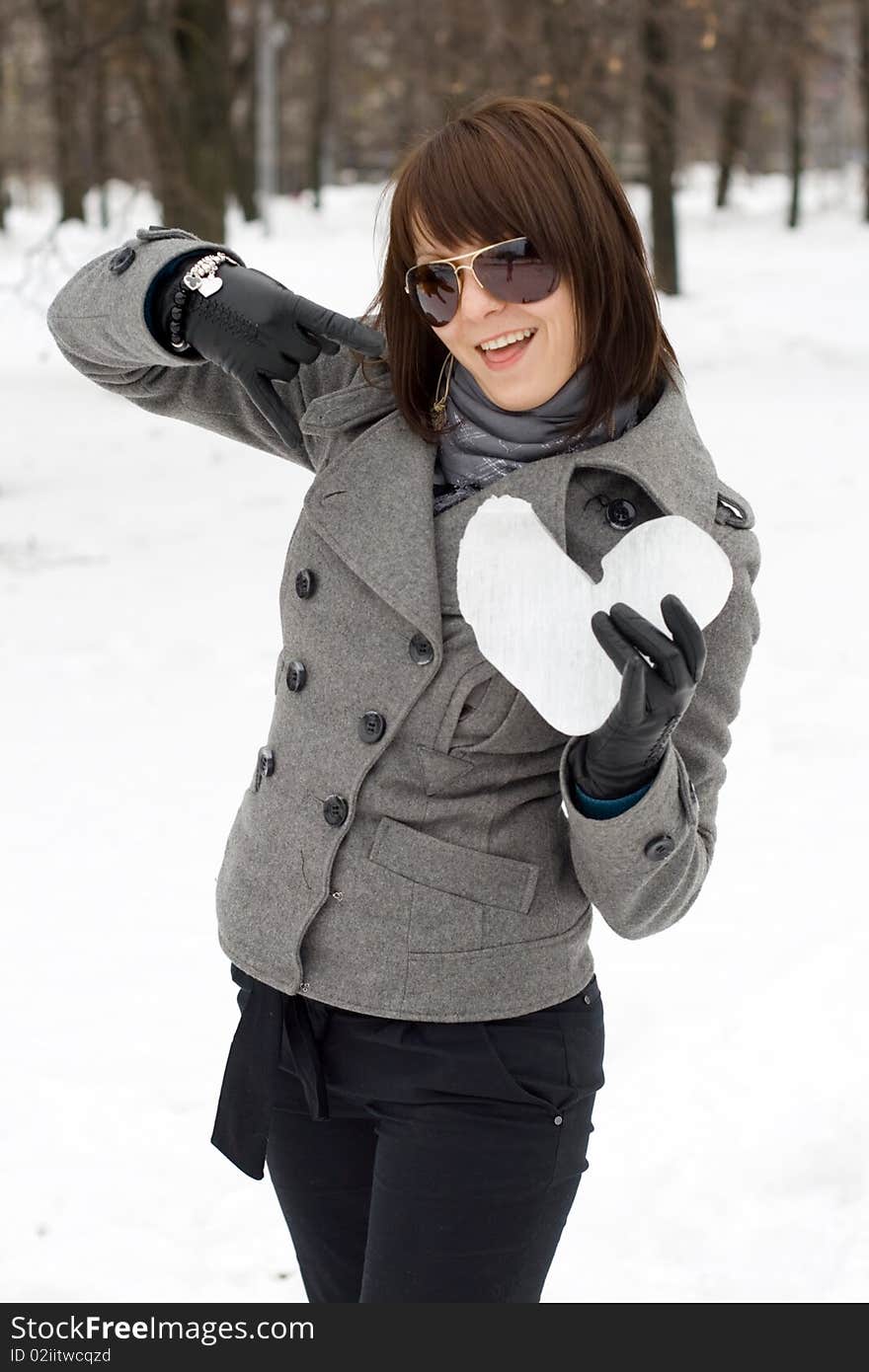 Girl holding an ice heart outdoor