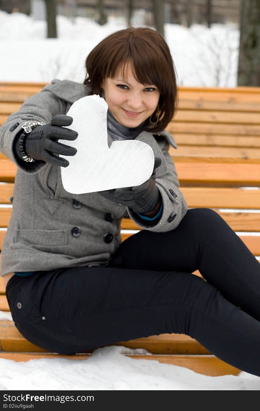 Girl holding an ice heart outdoor