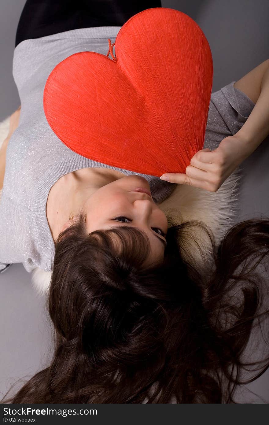 Beautiful woman holding red heart