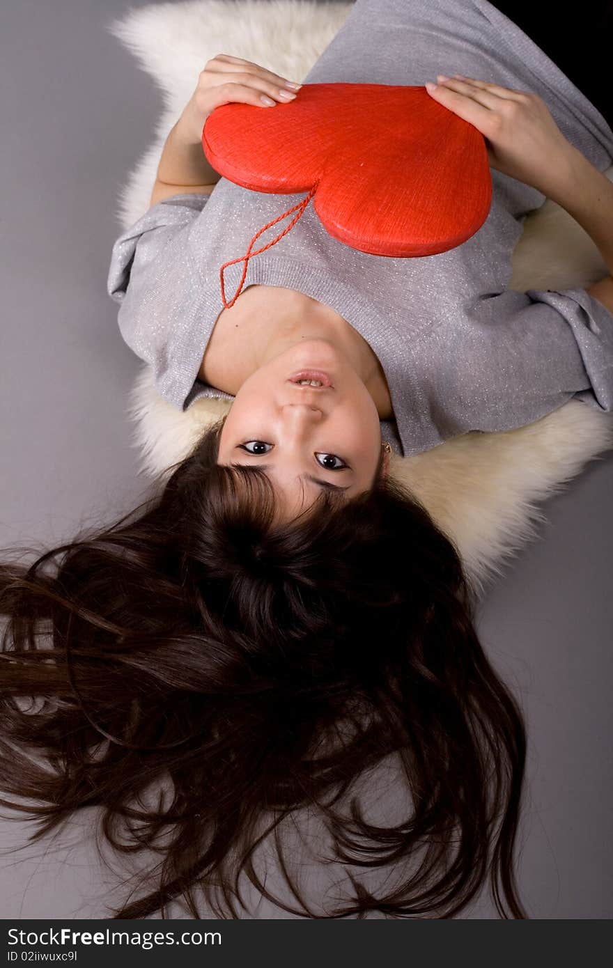 Beautiful woman holding red heart