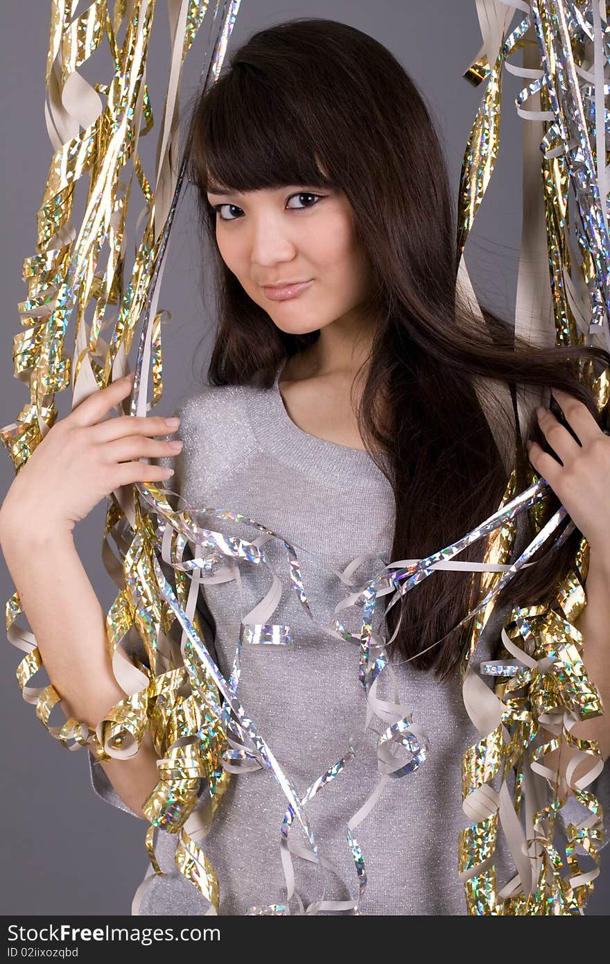 Girl standing among tinsel in studio