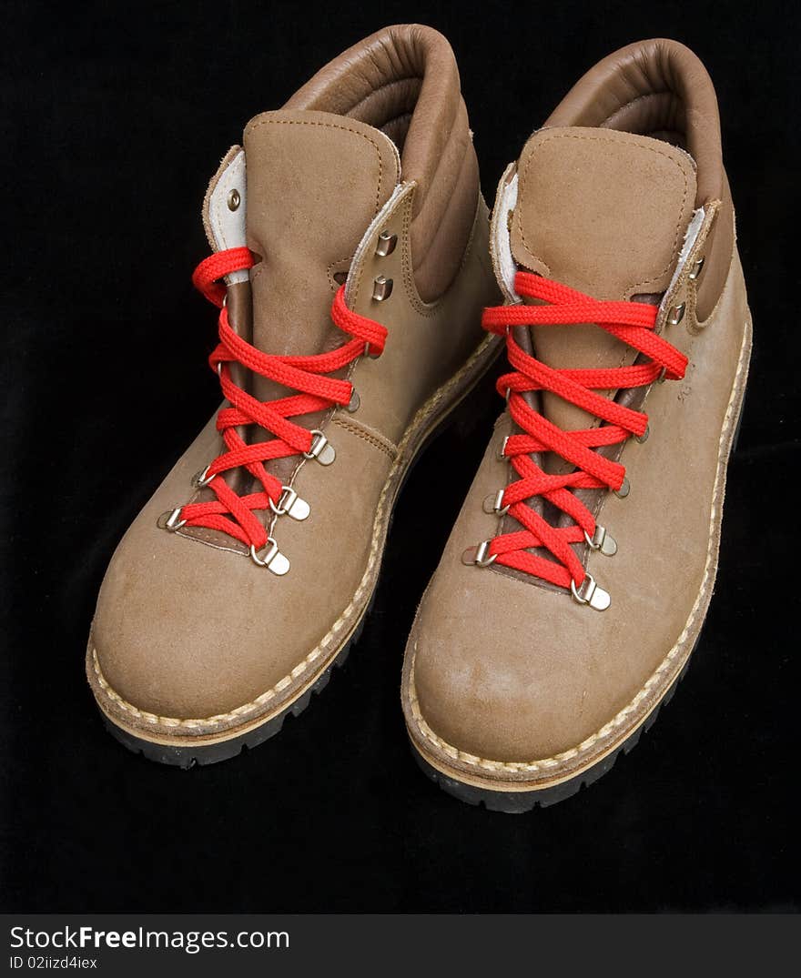 Hiking boots with red laces.