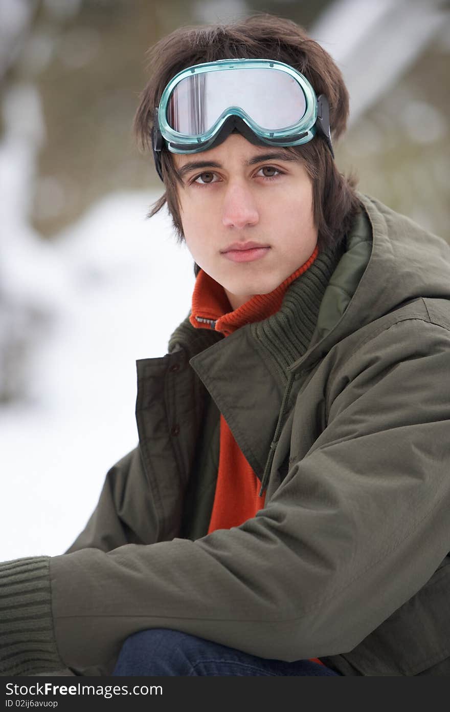 Teenage Boy Wearing Winter Clothes In Snowy Landscape