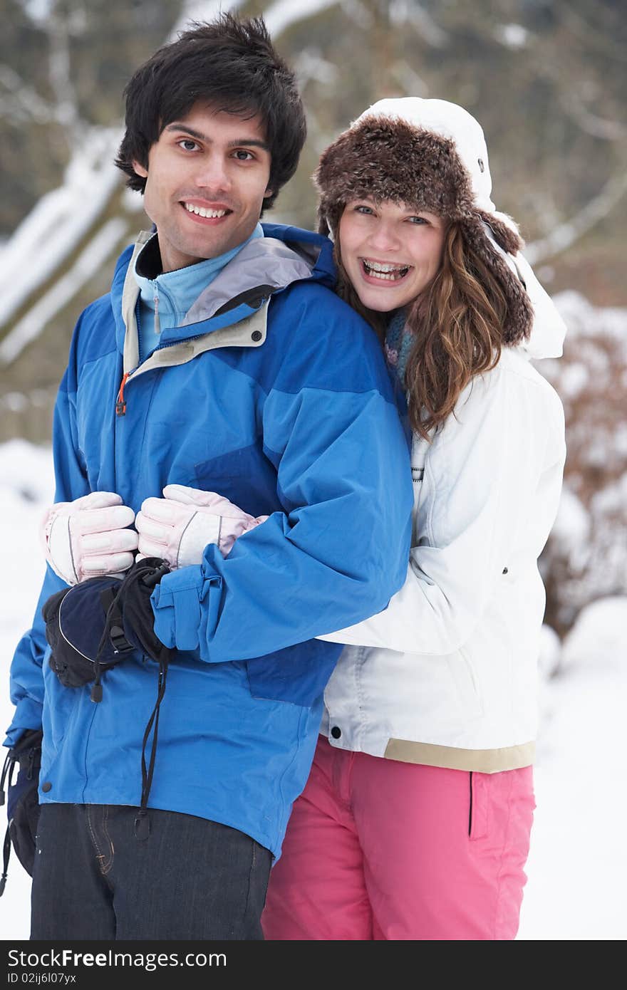 Romantic Teenage Couple In Snow