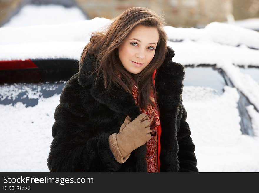 Close Up Of Teenage Girl Wearing Fur Coat In Snowy Landscape