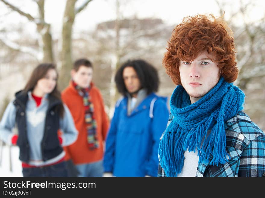 Group Of Teenage Friends Having Fun In Snowy Landscape Wearing Ski Clothing