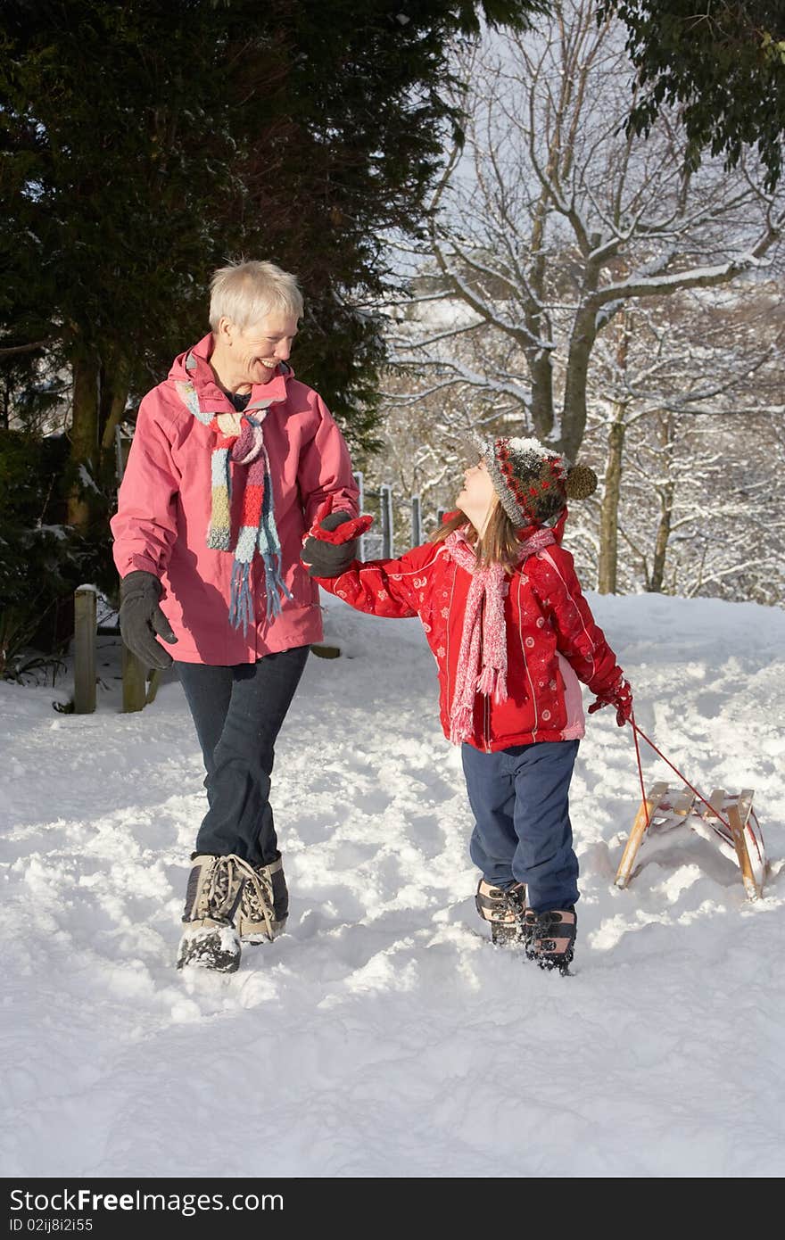 Young Girl With Grandmother Pulling Sledge