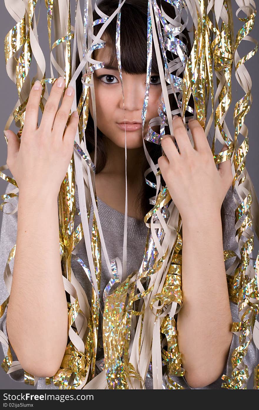 Girl standing among tinsel in studio