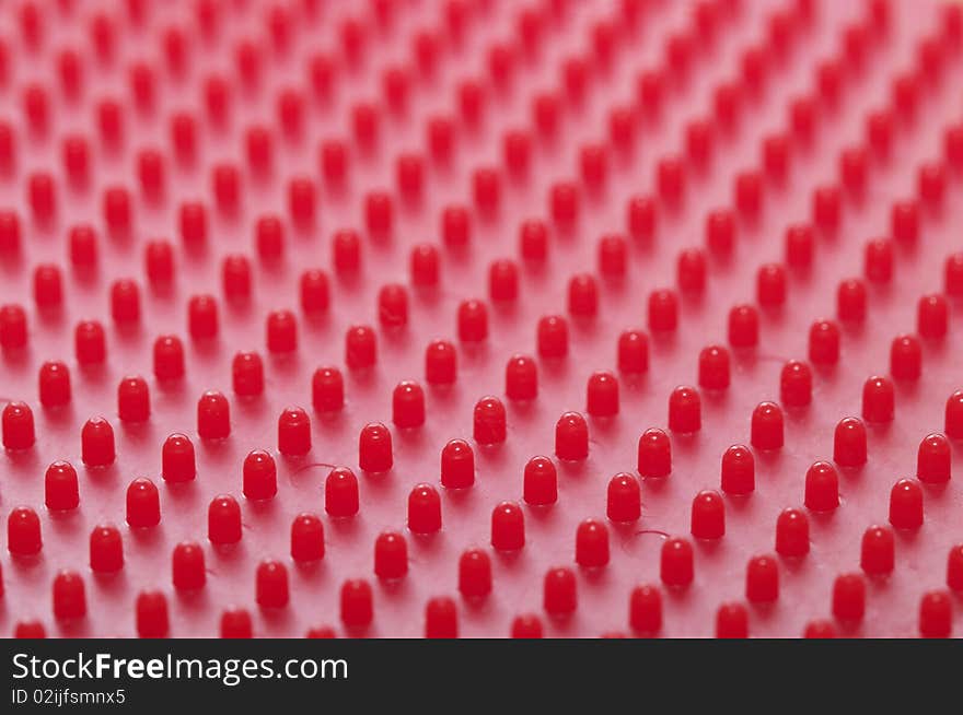 Red plastic pattern background macro shot (blurred background)