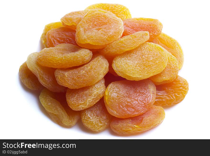 Dried apricots heap isolated over white background macro shot