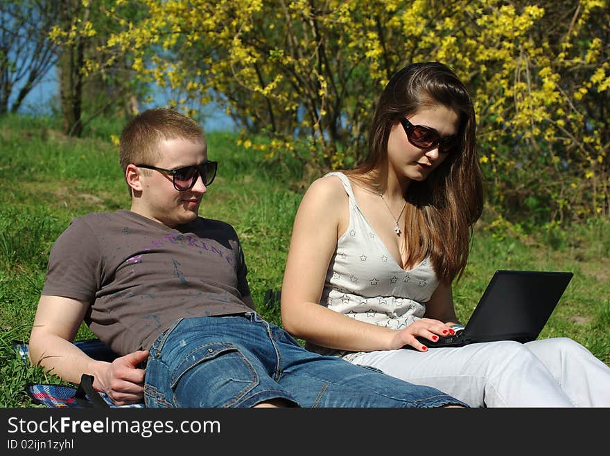 Young couple with laptop outdoors