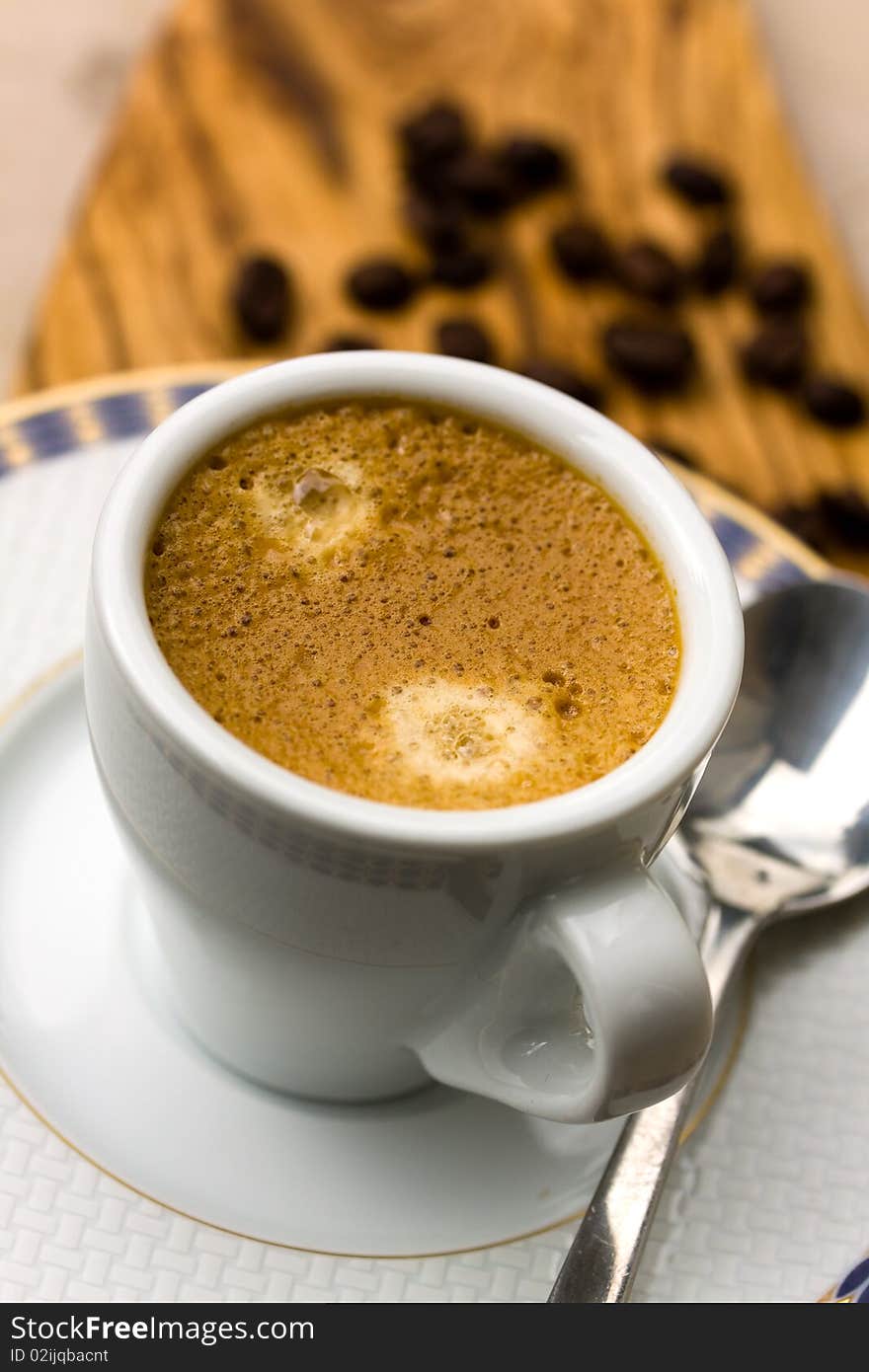 A Cup of Espresso with Coffee Beans