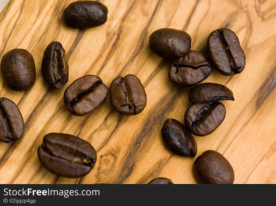 Coffee beans on the wooden background,close up