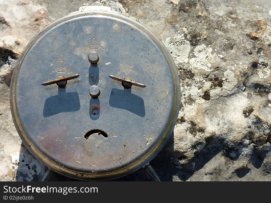 See an old alarm-clock shooted outside with shadow. Looks like the clock is sad. See an old alarm-clock shooted outside with shadow. Looks like the clock is sad.