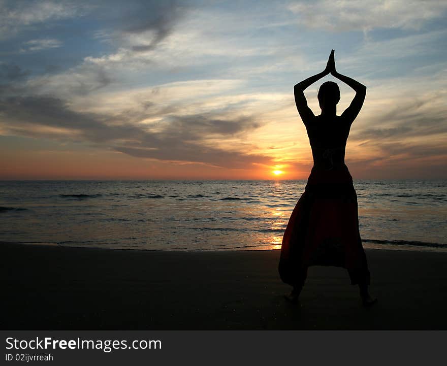 Silhouette of young beautiful woman on the beach