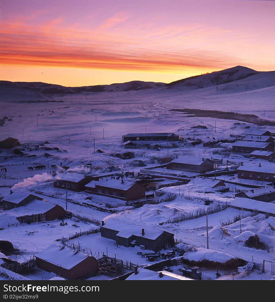 A village afetr snow in the sunrise