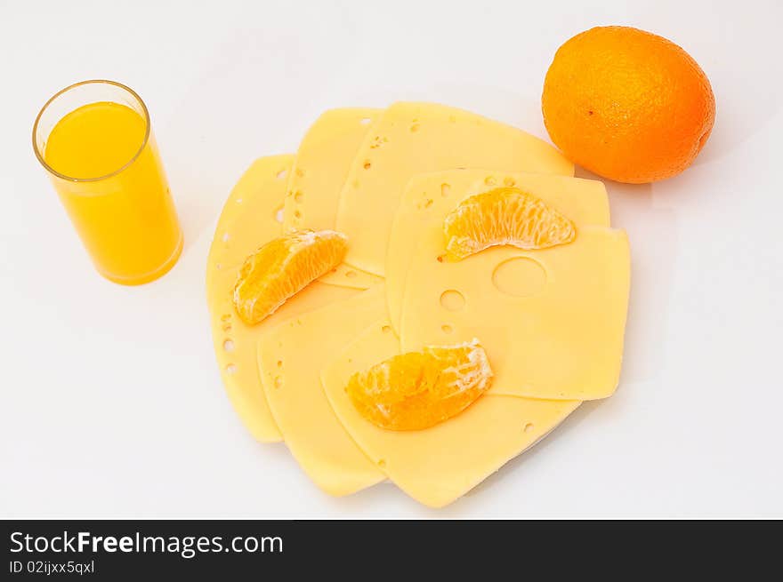 Yellow cheese  on the  plate.Orange juice  in a glass. Yellow cheese  on the  plate.Orange juice  in a glass.