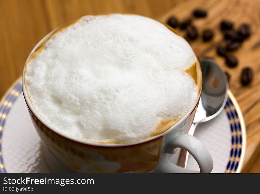 Cup of Cappuccino on the wooden Background