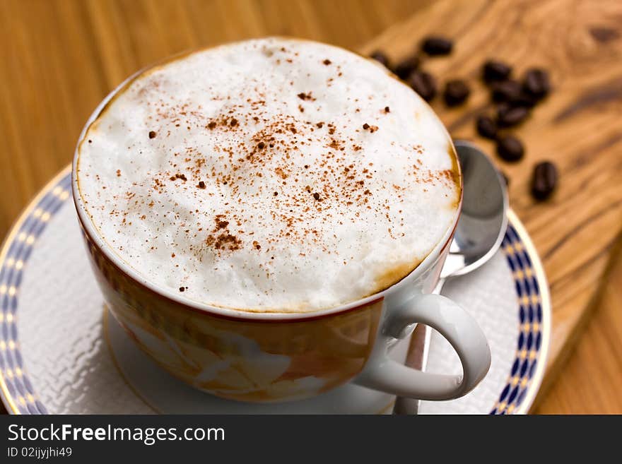 Cup of Cappuccino on the wooden Background