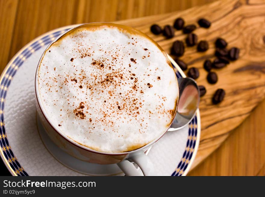 Cup Of Cappuccino On The Wooden Background