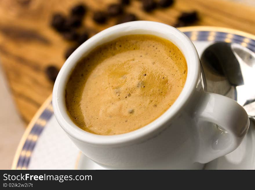 Cup of Espresso with Coffee Beans .