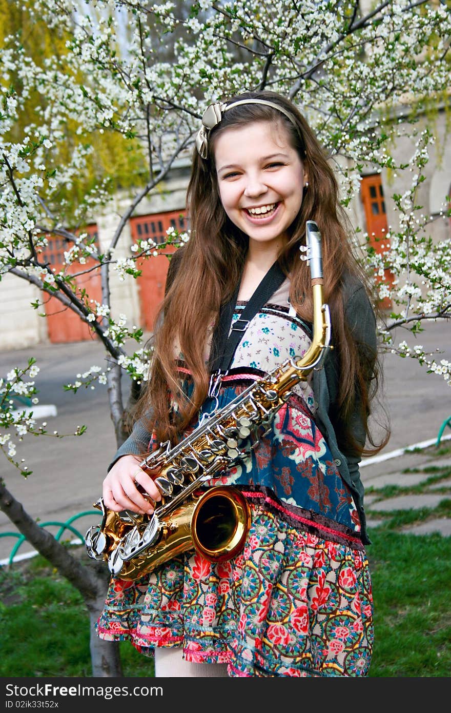 Beautiful Smiling Girl With Saxophone