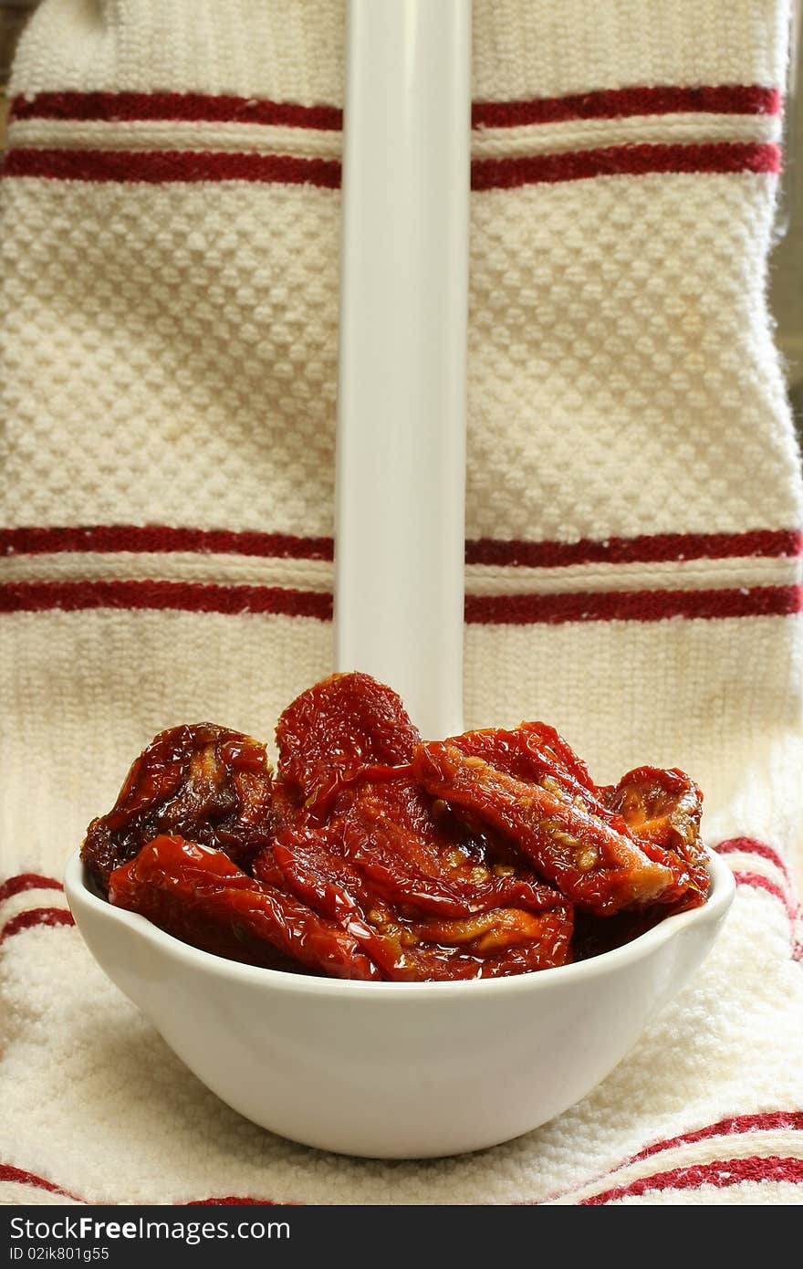 Sun Dried Tomatoes in Olive Oil sitting in large white kitchen spoon