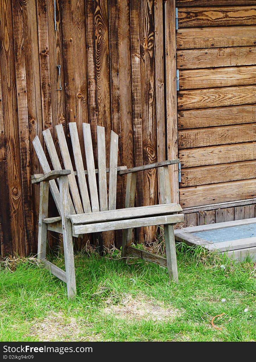 Old weatherworn garden chair in a fishing village on the iland of Gotland, Sweden. Old weatherworn garden chair in a fishing village on the iland of Gotland, Sweden.