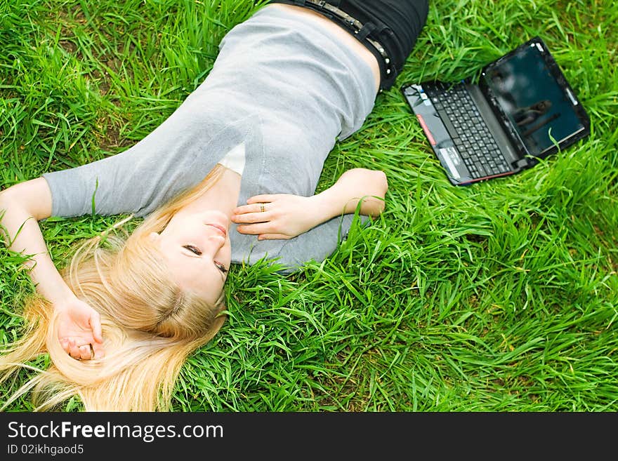 Series. The beautiful business woman with the laptop has a rest in the field