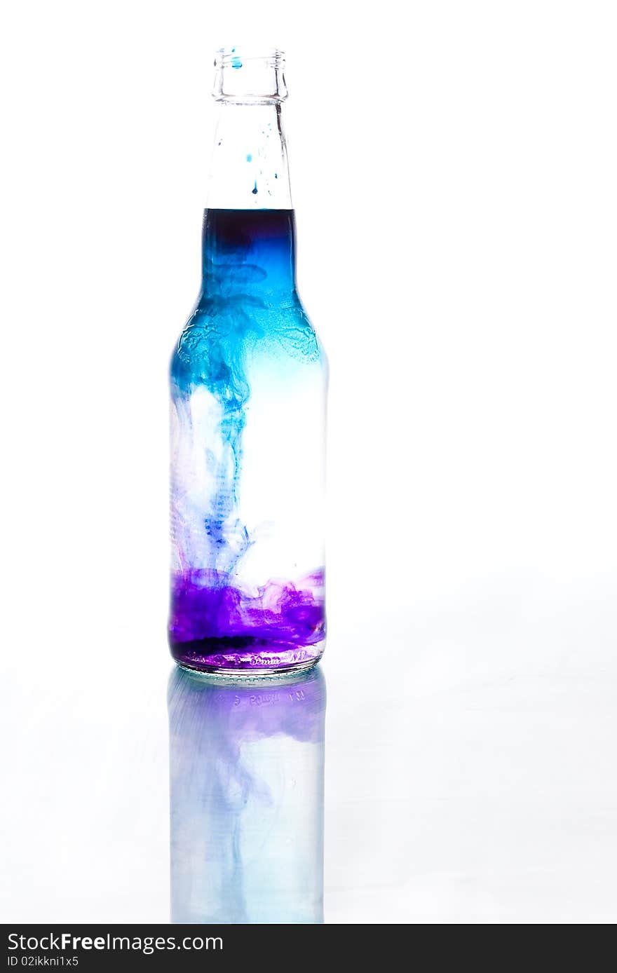 Blue and purple water, bottle with reflection. Blue and purple water, bottle with reflection