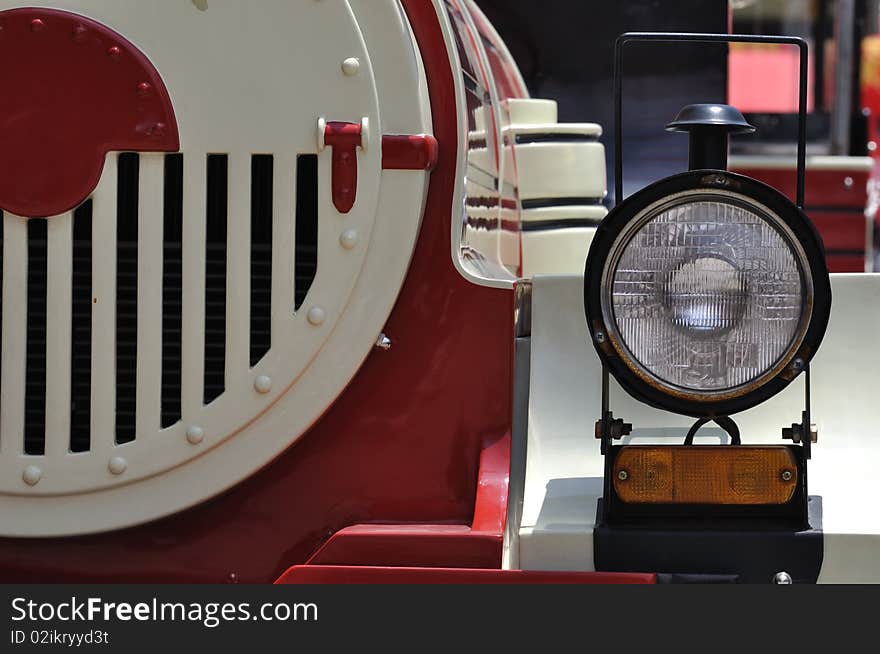 A head light of a small train in red and white color, which in wonderful shape and line. A head light of a small train in red and white color, which in wonderful shape and line.