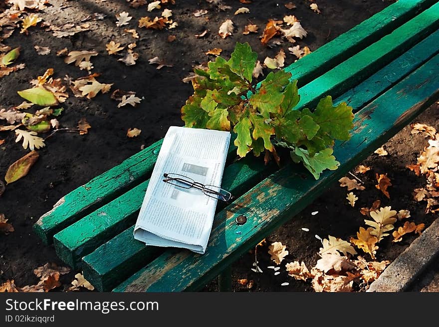 A lonely bench in the autumn park. A lonely bench in the autumn park