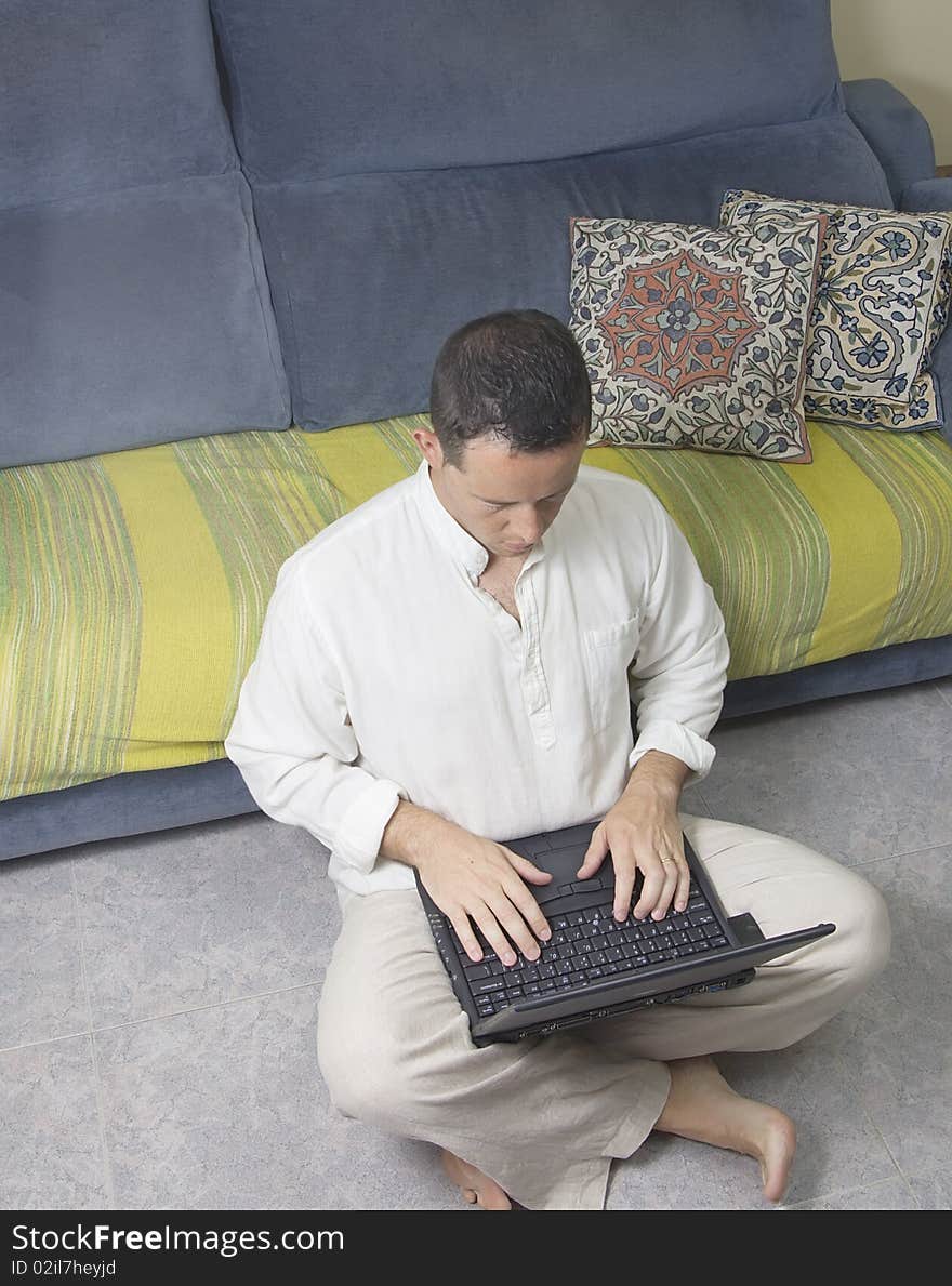 Portrait of a young adult on the ground with his laptop. Portrait of a young adult on the ground with his laptop