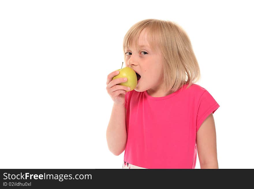 Young little girl eating an apple