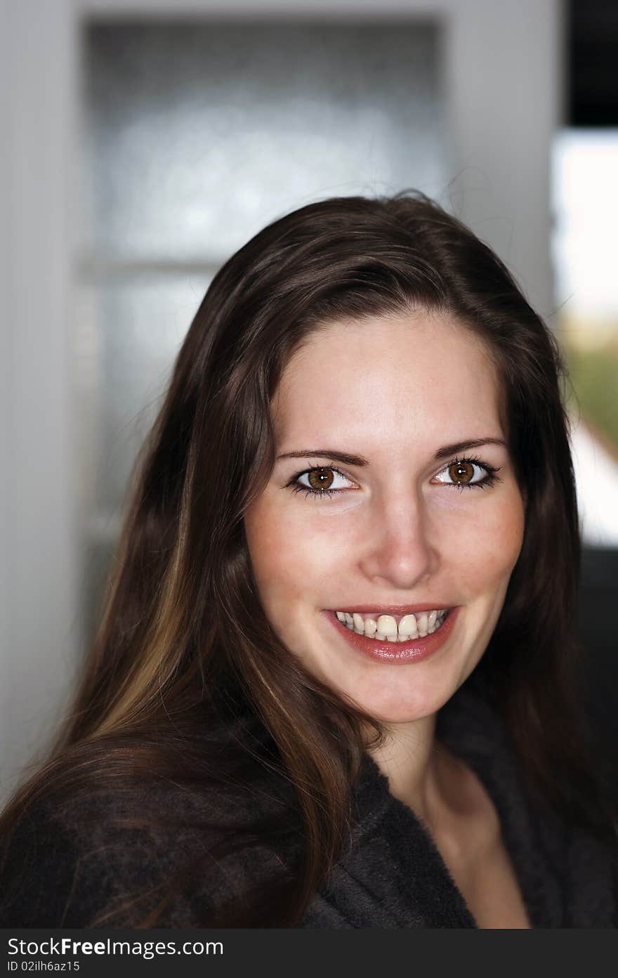 Headshot of a smiling woman at home