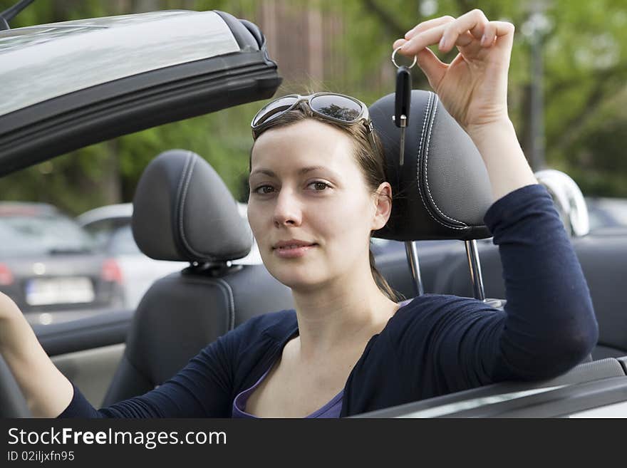 Young woman with keys in a cabriolet. Young woman with keys in a cabriolet