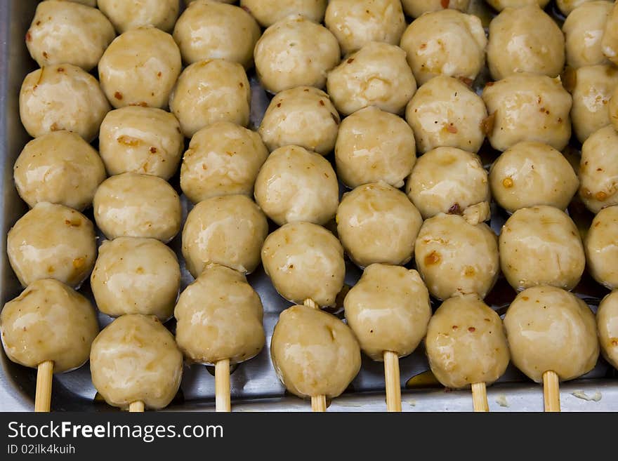 Meatballs on sticks, dipped in sweet chili sauce