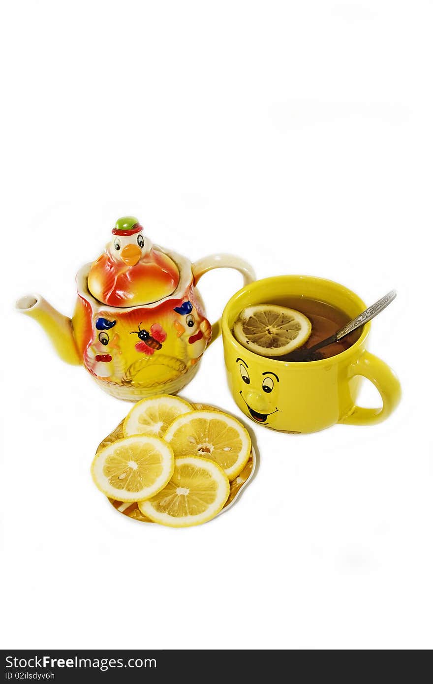 Funny kettle and a cup of tea with lemon on a white background. Funny kettle and a cup of tea with lemon on a white background