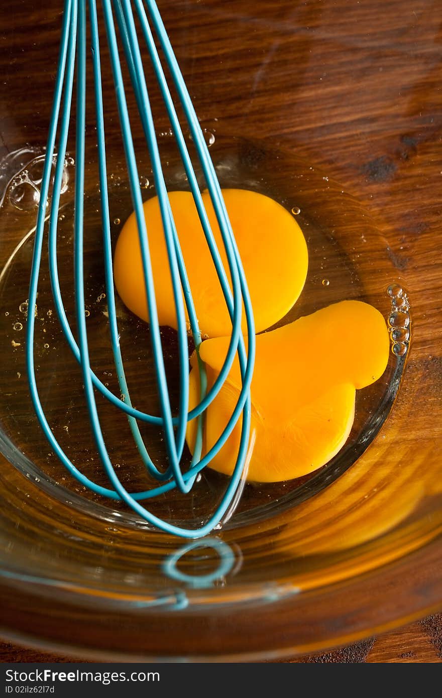 Photo of broken eggs which are ready to be beaten by the beater tool. Photo of broken eggs which are ready to be beaten by the beater tool