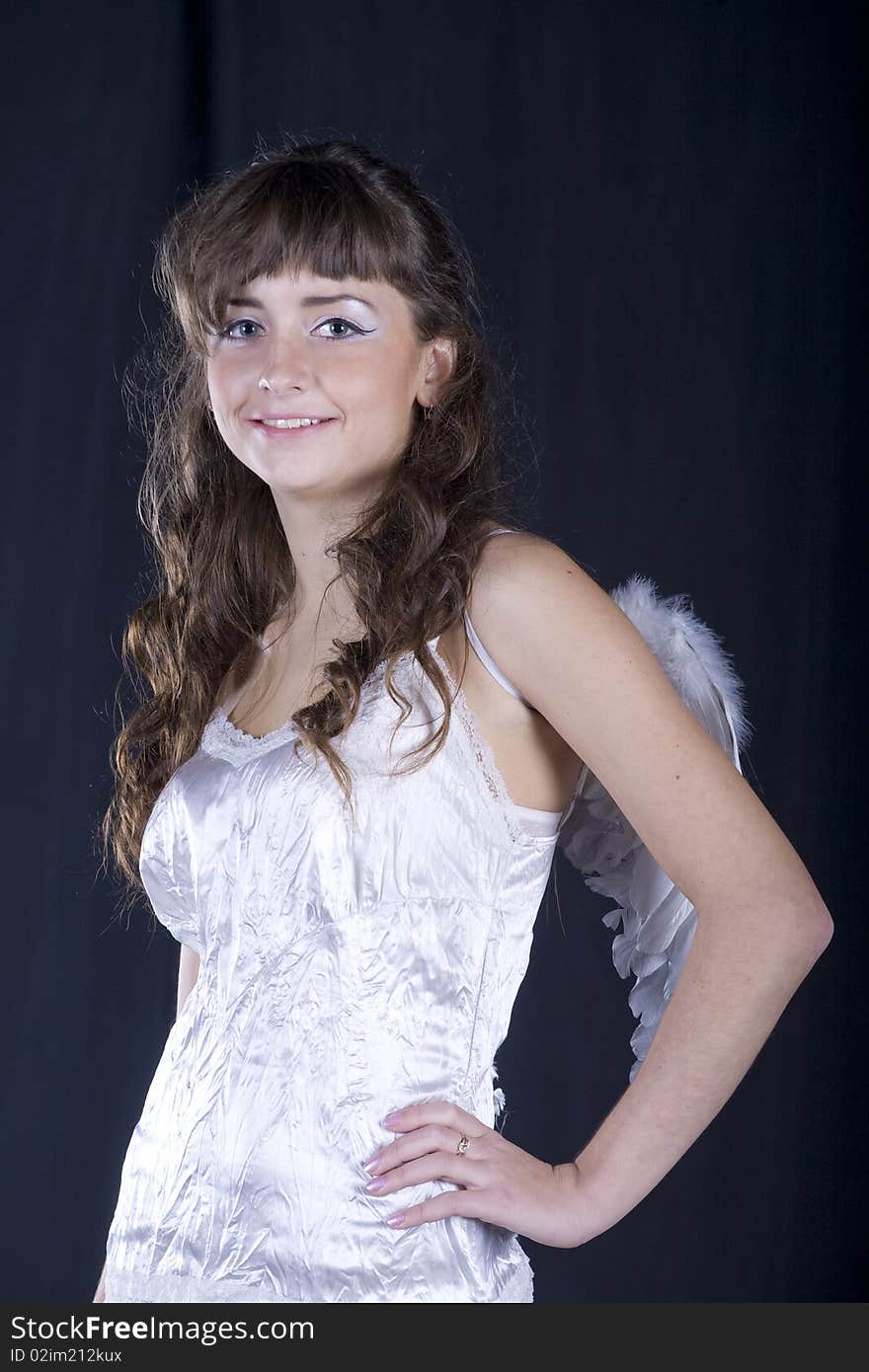 Young girl wearing angel wings