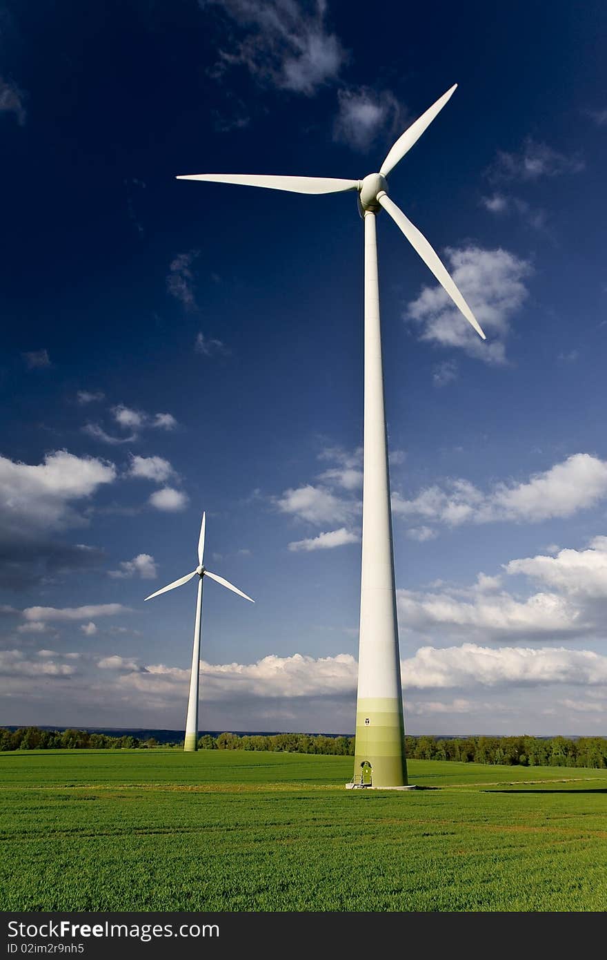 Windmills against a blue sky and clouds, alternative energy source