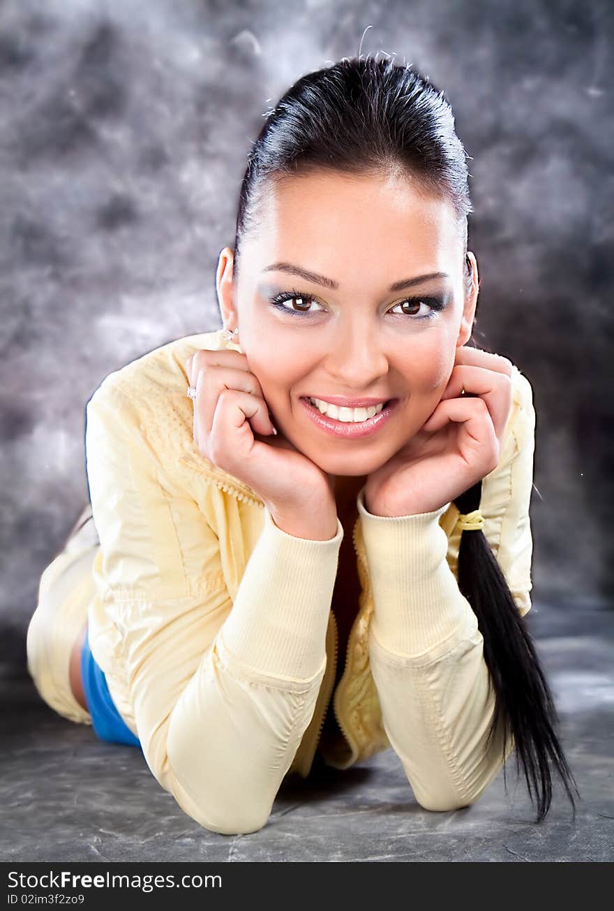 Pretty brunette wearing sport outfit and posing , studio shot