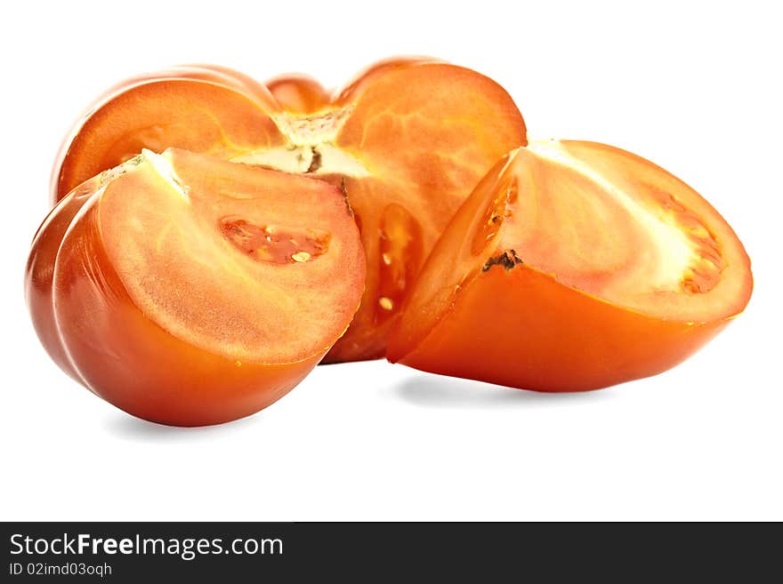 Tomato, cut in half on the green plate. Tomato, cut in half on the green plate