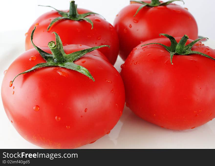 Close up image of four ripe tomatoes