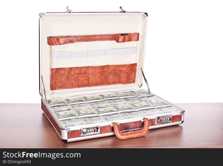 Brown briefcase full of hundred zloty money isolated on white. Brown briefcase full of hundred zloty money isolated on white